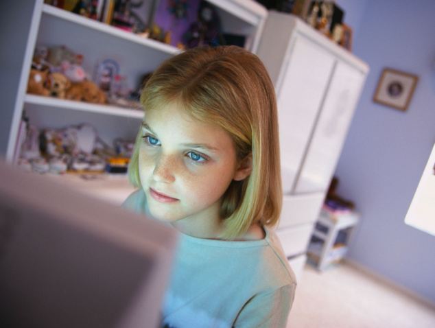 Teen at computer in bedroom